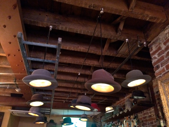 Hanging hat lights above the upstairs bar